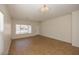 Bright living room features neutral walls, tile flooring, and ample natural light from large windows at 14552 W Hearn Rd, Surprise, AZ 85379