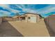 Large backyard with a covered patio and storage shed, enclosed by a block wall fence for privacy at 15134 N 138Th Ln, Surprise, AZ 85379