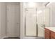 Bright bathroom featuring a glass-enclosed shower, a white door, and modern fixtures at 15134 N 138Th Ln, Surprise, AZ 85379