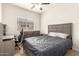 Comfortable bedroom featuring neutral decor, a large window, desk, and sleek furniture at 15134 N 138Th Ln, Surprise, AZ 85379