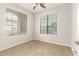 Bedroom with wood-look flooring, a ceiling fan, and a window with blinds at 15134 N 138Th Ln, Surprise, AZ 85379