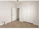 This bedroom includes wood-look flooring, a closet with sliding doors, and a white door at 15134 N 138Th Ln, Surprise, AZ 85379