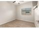 This bedroom includes wood-look flooring, a ceiling fan, and a window with blinds at 15134 N 138Th Ln, Surprise, AZ 85379