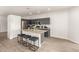 Modern kitchen features an island with barstool seating, granite countertops, stainless steel appliances, and wood-look flooring at 15134 N 138Th Ln, Surprise, AZ 85379