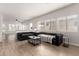 Spacious living room featuring modern gray sofas, wood-look flooring and plenty of natural light at 15134 N 138Th Ln, Surprise, AZ 85379