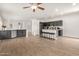 Bright and open living space with a kitchen island and barstool seating at 15134 N 138Th Ln, Surprise, AZ 85379