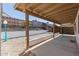 The covered patio offers shade with a view of the landscaped backyard and a sturdy privacy fence at 1633 E Beverly Ln, Phoenix, AZ 85022