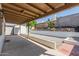 An inviting covered back patio leads to a landscaped backyard with white rock and a sturdy privacy fence at 1633 E Beverly Ln, Phoenix, AZ 85022