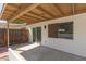 A covered back patio has white siding, neutral trim and a sliding glass door to the interior at 1633 E Beverly Ln, Phoenix, AZ 85022