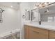 Modern bathroom with white tile shower, rainfall shower head, and wood vanity at 1633 E Beverly Ln, Phoenix, AZ 85022