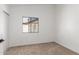 Small bedroom featuring neutral carpet and a window at 1633 E Beverly Ln, Phoenix, AZ 85022