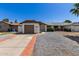 Charming single-story home with a brown garage door and low-maintenance landscaping at 1633 E Beverly Ln, Phoenix, AZ 85022