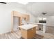 A modern kitchen with waterfall island, new appliances and wood look floors at 1633 E Beverly Ln, Phoenix, AZ 85022