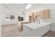 Open concept kitchen with waterfall island, new stainless steel appliances, and wood look tile at 1633 E Beverly Ln, Phoenix, AZ 85022