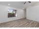 Bright and spacious living room showcasing fresh paint, recessed lights, and wood look floors at 1633 E Beverly Ln, Phoenix, AZ 85022