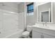 Clean, bright bathroom with shower-tub combo, white vanity, and modern fixtures at 16521 W Magdalena Ln, Goodyear, AZ 85338