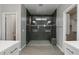 This bathroom features a tile shower with a glass door and a built in shower head at 16521 W Magdalena Ln, Goodyear, AZ 85338
