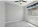 Bright bedroom with carpet flooring, a modern ceiling fan, and a large window at 16521 W Magdalena Ln, Goodyear, AZ 85338