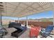 Relaxing covered patio area featuring comfortable lounge seating and colorful rocking chairs at 16521 W Magdalena Ln, Goodyear, AZ 85338