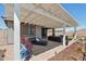 Spacious covered patio with outdoor seating, lounge chairs, and desert landscaping at 16521 W Magdalena Ln, Goodyear, AZ 85338
