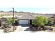 Charming home showcasing a tile roof, two-car garage, and desert landscaping at 16521 W Magdalena Ln, Goodyear, AZ 85338