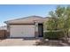 Charming single-story home featuring a well-maintained front yard and attached two-car garage at 16521 W Magdalena Ln, Goodyear, AZ 85338