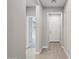 Bright hallway with wood-look tile flooring leading to various rooms at 16521 W Magdalena Ln, Goodyear, AZ 85338
