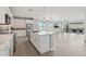 A spacious kitchen features white cabinets, a large island, and stainless steel appliances, creating a bright and modern cooking space at 16521 W Magdalena Ln, Goodyear, AZ 85338