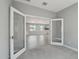 Living room featuring wood floors, recessed lights, a pendant light fixture, and a large TV screen at 16521 W Magdalena Ln, Goodyear, AZ 85338