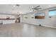 An open concept living room connects to a modern kitchen, creating an inviting living space with lots of natural light at 16521 W Magdalena Ln, Goodyear, AZ 85338