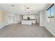 An open concept living room showcases a kitchen with a kitchen island and hardwood floors, offering a spacious and inviting area at 16521 W Magdalena Ln, Goodyear, AZ 85338