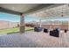 This patio features mountain views, brick floors, a pergola, and outdoor seating with cushions at 16521 W Magdalena Ln, Goodyear, AZ 85338
