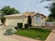 Charming single story home featuring a well-maintained lawn, desert landscaping, and a two car garage at 16646 N 35Th Way, Phoenix, AZ 85032