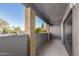 Outdoor patio with gray wood paneling, stucco pillars, and string lights at 1730 W Emelita Ave # 2027, Mesa, AZ 85202