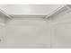Empty white closet with white bars for hanging clothes and white walls at 1730 W Emelita Ave # 2027, Mesa, AZ 85202