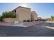 Complex featuring covered parking, desert landscaping and colorful buildings at 1730 W Emelita Ave # 2027, Mesa, AZ 85202