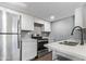 Modern kitchen with stainless steel appliances, white cabinets, and quartz countertops at 1730 W Emelita Ave # 2027, Mesa, AZ 85202