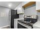Updated kitchen with white cabinets, solid surface countertops, and stainless steel appliances at 1730 W Emelita Ave # 2027, Mesa, AZ 85202