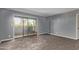 Neutral living room with sliding glass doors, wood-look floors, and baseboards at 1730 W Emelita Ave # 2027, Mesa, AZ 85202