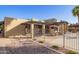 Outdoor pool area with a metal fence, lounge chairs, umbrellas, and desert landscaping at 1730 W Emelita Ave # 2027, Mesa, AZ 85202