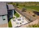 Lush backyard featuring an outdoor kitchen and cozy fire pit area with picturesque views of the adjacent golf course at 17362 W Wildwood St, Surprise, AZ 85388