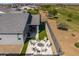 Scenic aerial perspective of a backyard featuring a fire pit, outdoor kitchen, and access to a lush green golf course at 17362 W Wildwood St, Surprise, AZ 85388