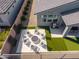 Overhead view of a backyard featuring an inviting fire pit area, an outdoor grill, and verdant artificial turf at 17362 W Wildwood St, Surprise, AZ 85388