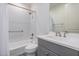 Bathroom featuring subway tile in the shower, a gray vanity, and black and white floor tiles at 17362 W Wildwood St, Surprise, AZ 85388