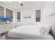 Cozy bedroom with a ceiling fan, wood-look floors, and a media center with a flat screen television at 17362 W Wildwood St, Surprise, AZ 85388