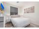 Bright bedroom featuring a queen bed, white walls, wood look floors, and stylish decor at 17362 W Wildwood St, Surprise, AZ 85388