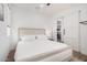 Comfortable bedroom features a plush bed, soft lighting, and an open doorway to the kitchen at 17362 W Wildwood St, Surprise, AZ 85388