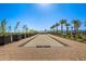Bocce ball court with perimeter pavers and manicured landscaping at 17362 W Wildwood St, Surprise, AZ 85388
