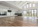 A modern fitness center with wood flooring, large windows, and ample workout space at 17362 W Wildwood St, Surprise, AZ 85388