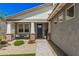Charming front porch features decorative stone accents, a cozy seating area, and well-maintained landscaping at 17362 W Wildwood St, Surprise, AZ 85388